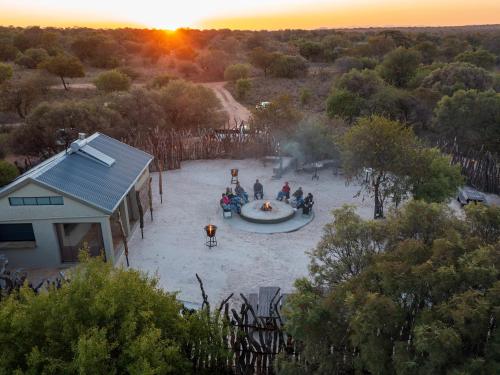a group of people sitting around a fountain at sunset at Dikhololo in Brits