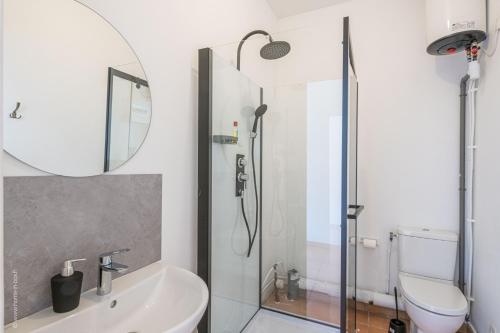 a bathroom with a shower and a sink and a toilet at Logis de beauce in Boisgasson