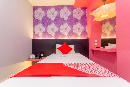 ein Schlafzimmer mit einem Bett mit einer roten Decke darauf in der Unterkunft OYO 902 Rooms Boutique Hotel in Johor Bahru