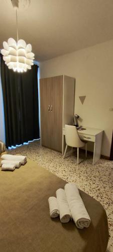 a bedroom with a desk and a bed with three pillows at Il sospiro B&B in Spinoso
