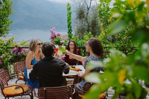 a group of women sitting around a table with wine glasses at Hotel Limone in Limone sul Garda