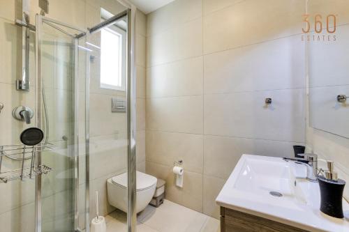 a bathroom with a shower and a toilet and a sink at Wonderful marina 3BR home, with LUX interior w/AC by 360 Estates in Tal-Pietà