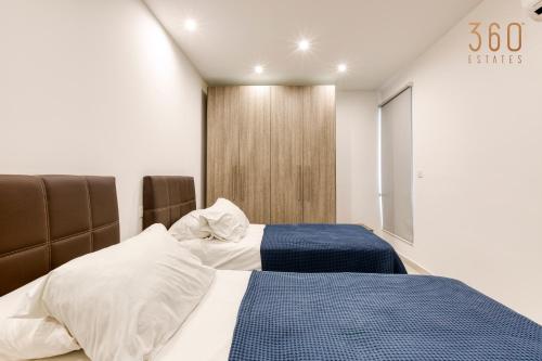 a bedroom with two beds and a sign that says senses at Wonderful marina 3BR home, with LUX interior w/AC by 360 Estates in Tal-Pietà