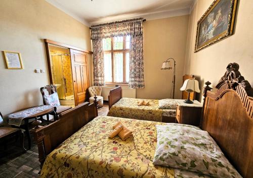 a hotel room with two beds and a chair at Willa Bajka in Inowrocław
