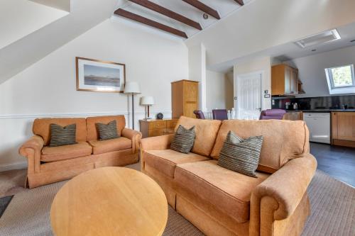 a living room with two couches and a table at The Kenmore Club in Kenmore