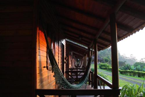 a hammock hanging from the side of a building at POUSADA ITAIMBÉ in Praia Grande
