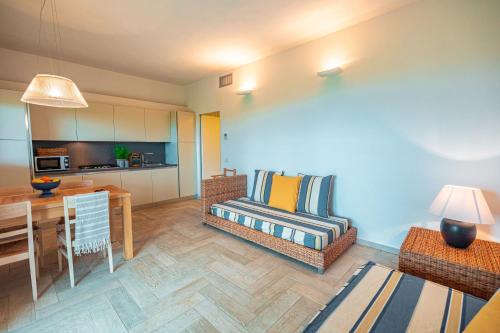 a living room with a couch and a dining room at Fattoria delle Ripalte in Capoliveri