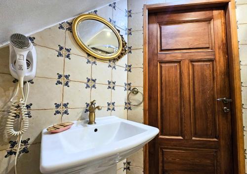 a bathroom with a sink and a mirror at Willa Bajka in Inowrocław