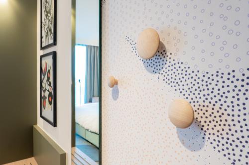 a room with a wall with white dots on it at voco Brussels City North by IHG in Vilvoorde