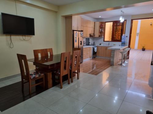a kitchen and dining room with a table and chairs at Martina House in Iquitos