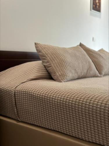 a bed with two pillows on top of it at Villa 4 Seasons in São Roque do Pico