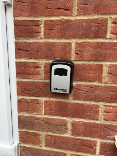 a soap dispenser on the side of a brick wall at En-suite Double Room - Private Entrance & Free Parking in West Drayton
