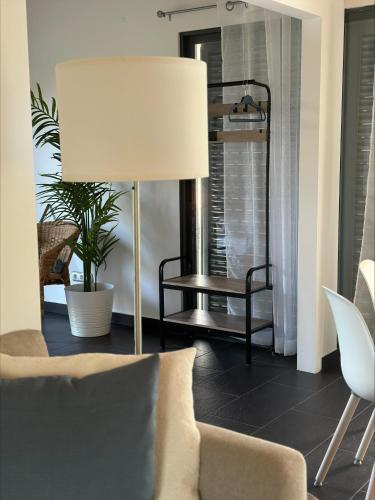 a living room with a lamp and a chair at Villa 4 Seasons in São Roque do Pico