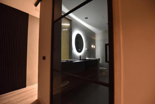 a bathroom with a sink and a mirror at Two Couples Leisure Art Motel in Tainan