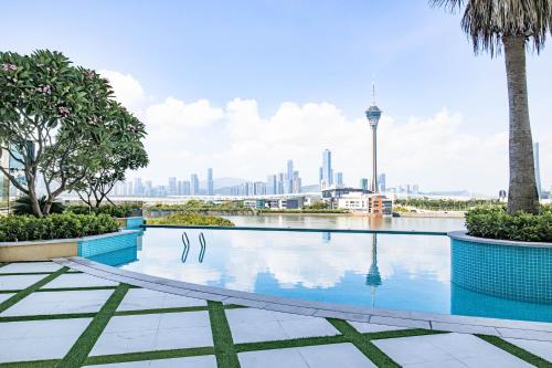 a swimming pool with a view of the city at YOHO Treasure Island Hotel in Macau