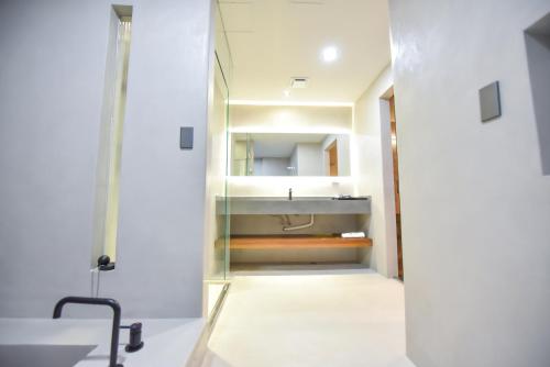 a bathroom with a sink and a mirror at Two Couples Leisure Art Motel in Tainan