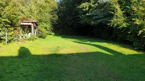 a shadow of a person on the grass at Ferienhaus mit großem Garten in Bad Gandersheim