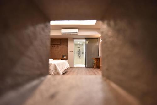 a view of a bedroom through a hole in a wall at Two Couples Leisure Art Motel in Tainan