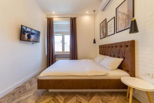 a small bedroom with a bed and a table at Central Dayflat Apartments in Kyiv