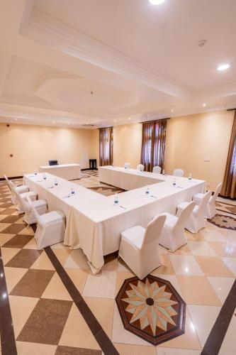a large room with a large table and white chairs at Golden Tulip Stone Town Boutique in Zanzibar City