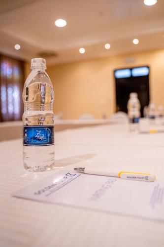 a bottle of water sitting on top of a table at Golden Tulip Stone Town Boutique in Zanzibar City