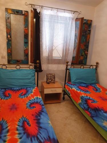 Postel nebo postele na pokoji v ubytování Villetta in Residence La Bouganville