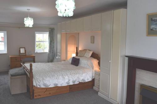 a bedroom with a bed and a fireplace at Dee View in Holywell