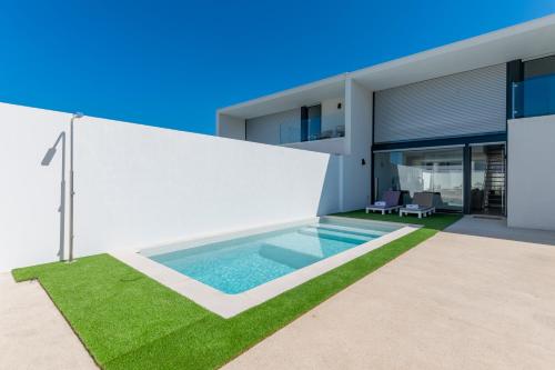 a swimming pool in the backyard of a house at BmyGuest Collection - Meco Sunset & Pool Villa in Sesimbra