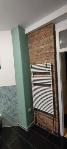 a bathroom with a brick wall and a window at Zum Fuchsbau - Schöneiche bei Berlin in Schöneiche