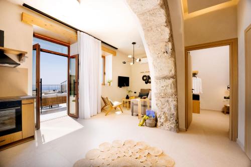 a living room with a view of the ocean at Mirthea Suites in Myrthios