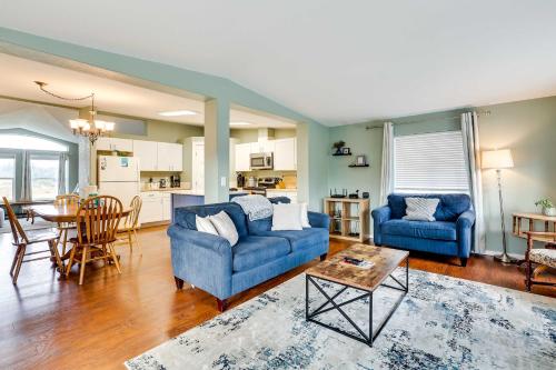 a living room with two blue couches and a table at Serene Sequim Retreat with Deck Pets Welcome! in Sequim