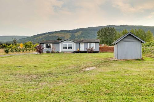 a house in the middle of a grassy field at Serene Sequim Retreat with Deck Pets Welcome! in Sequim