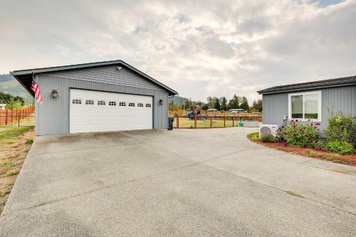 a garage with a flag in front of a house at Serene Sequim Retreat with Deck Pets Welcome! in Sequim