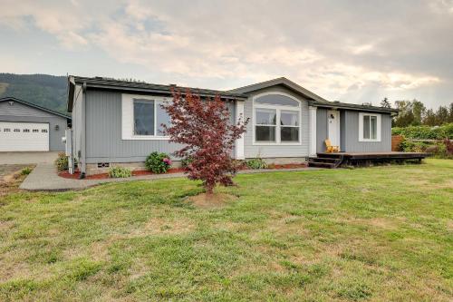 a house with a tree in a yard at Serene Sequim Retreat with Deck Pets Welcome! in Sequim