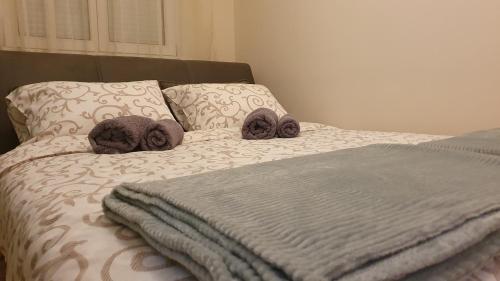 a bed with two stuffed animals on top of it at Apartman Iris in Niš