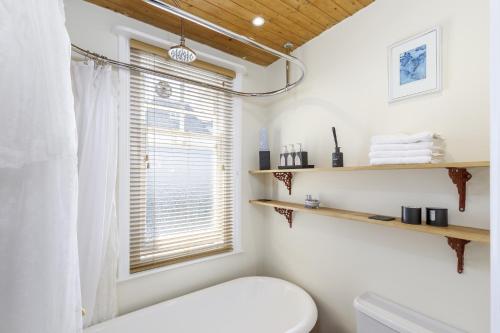 a bathroom with a toilet and a window at Finest Retreats - Pittodrie Guest House - Room 3 in Brighton & Hove