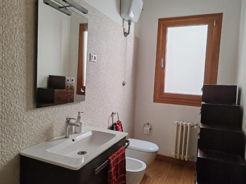 a bathroom with a sink and a toilet and a mirror at Domus Cornelia in Rome