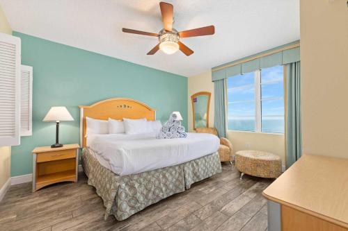 a hotel room with a bed and a ceiling fan at Luxury 3BR Villa Wyndham Ocean Walk Resort in Daytona Beach
