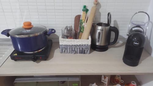 a kitchen counter with a pot and utensils at the lighthouse accommodation in Taranto