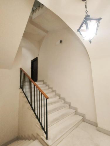 a stairway with a white wall and a stair case at Andrea's 12 in Bari