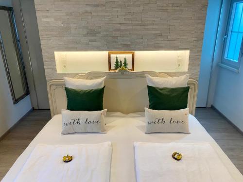 two bees sitting on a bed with two pillows at Apartment 3 Tannen in Russbach am Pass Gschütt