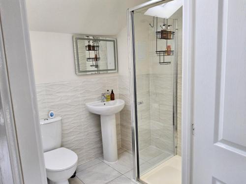 a bathroom with a shower and a toilet and a sink at 5 Star Luxury Small Cosy House with Lake View in Doncaster