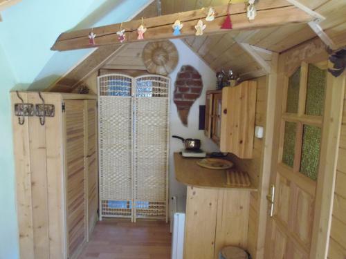 a cabin with wooden walls and a kitchen with a counter at Pokoje Jola Zakopane in Zakopane