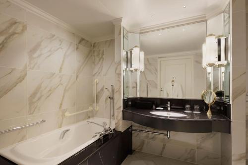 a bathroom with a tub and a sink and a mirror at The Westin Tokyo in Tokyo