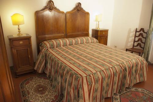a bedroom with a bed and two night stands at Anacleto in Collodi