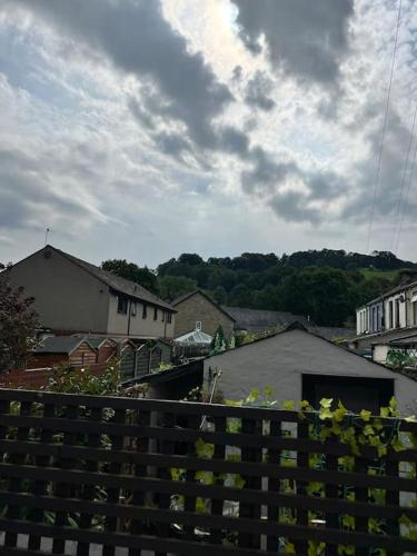 a view of a town from behind a wooden fence at Cottage in Whalley in Whalley