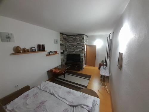 a living room with a bed and a fireplace at Quiet & Cosy Hillside Hideway Near Bus & Train St in Sarajevo