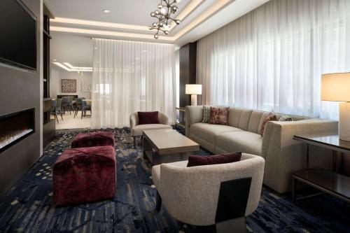 a living room with a couch and chairs and a table at Residence Inn by Marriott Oakland Downtown in Oakland