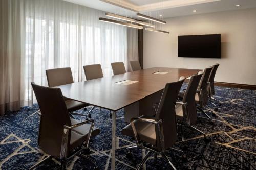 a conference room with a large wooden table and chairs at Residence Inn by Marriott Oakland Downtown in Oakland