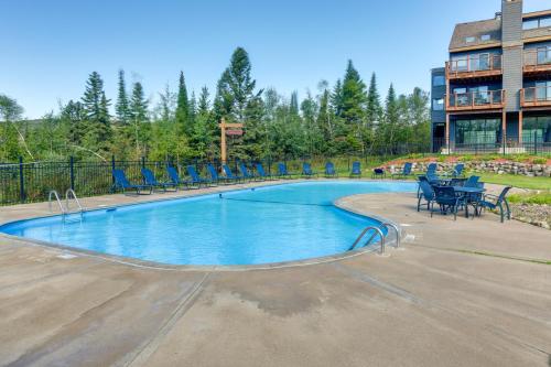 a swimming pool with chairs and tables in a building at Cozy Alpine Escape Ski-InandOut at Lutsen Mtns in Lutsen